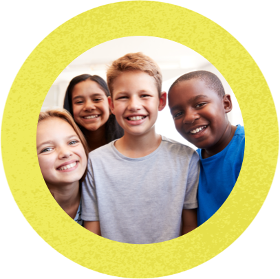 Smiling boy standing and surrounded by three smiling friends