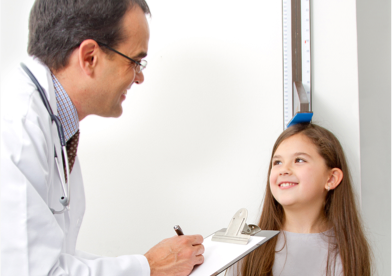 Young child being measured for height with a stadiometer  by a health care provider
