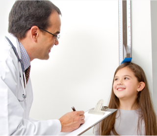 Young child being measured for height with a stadiometer  by a health care provider